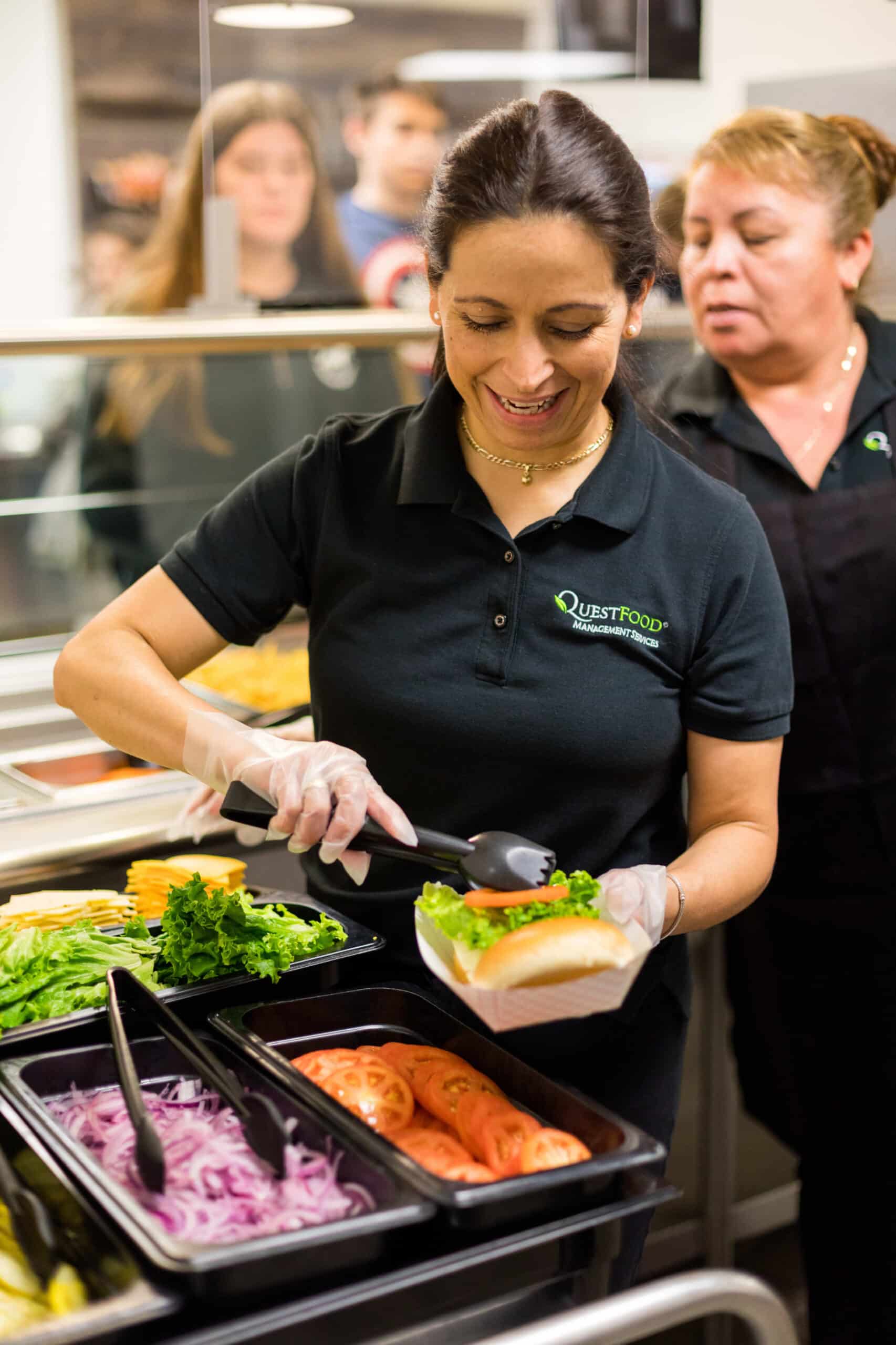 Woman wearing a black shirt, standing confidently with a neutral expression.