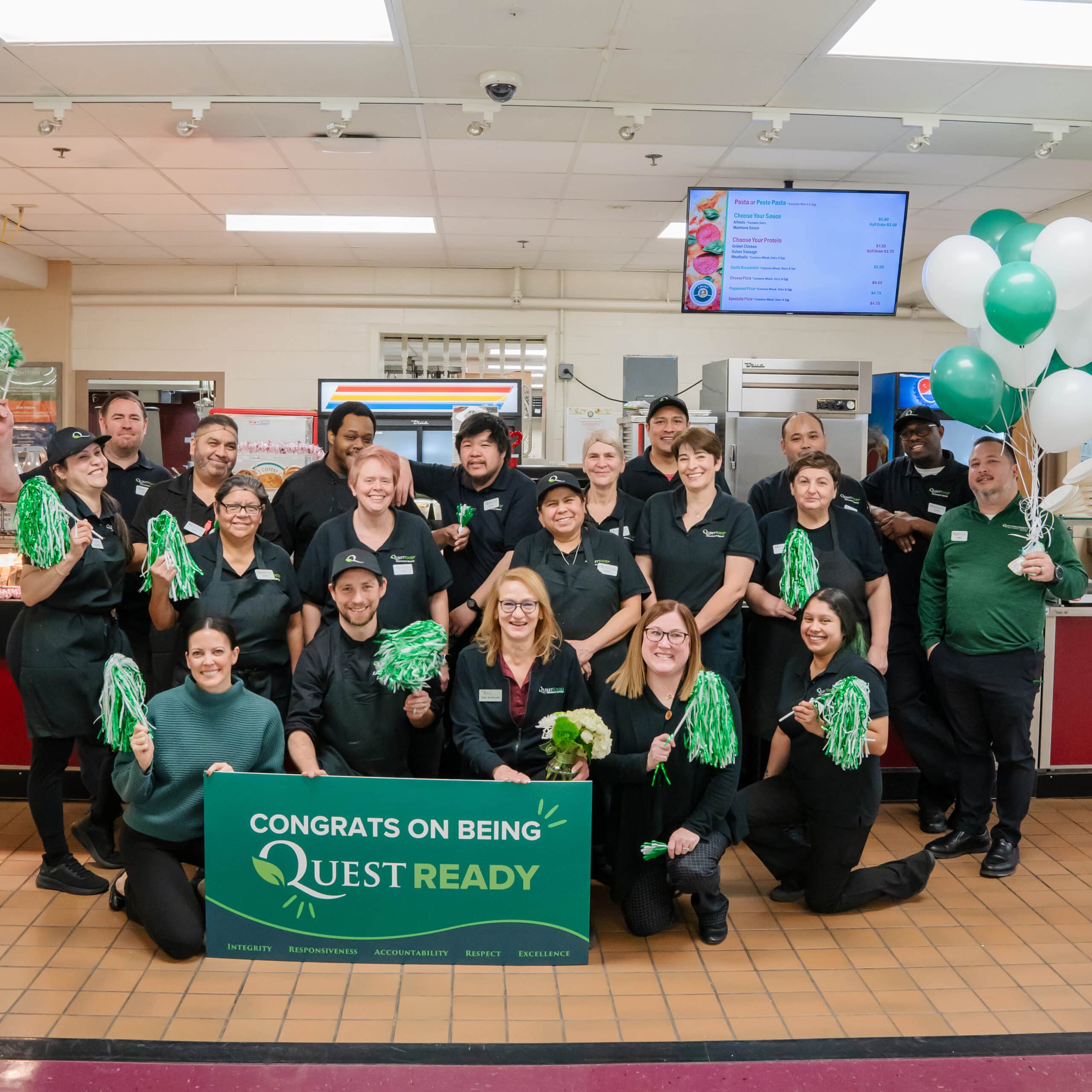 Group holding Quest Ready sign