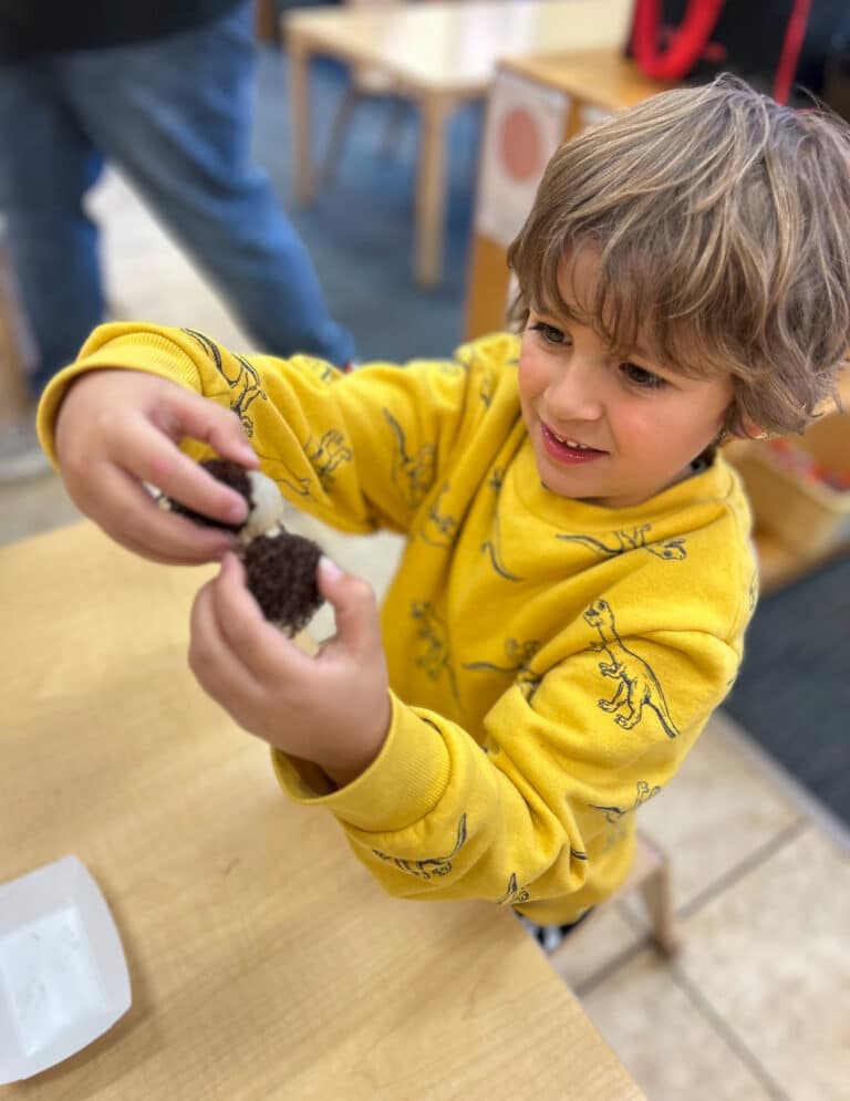 Student holds a Rambutan for the first time