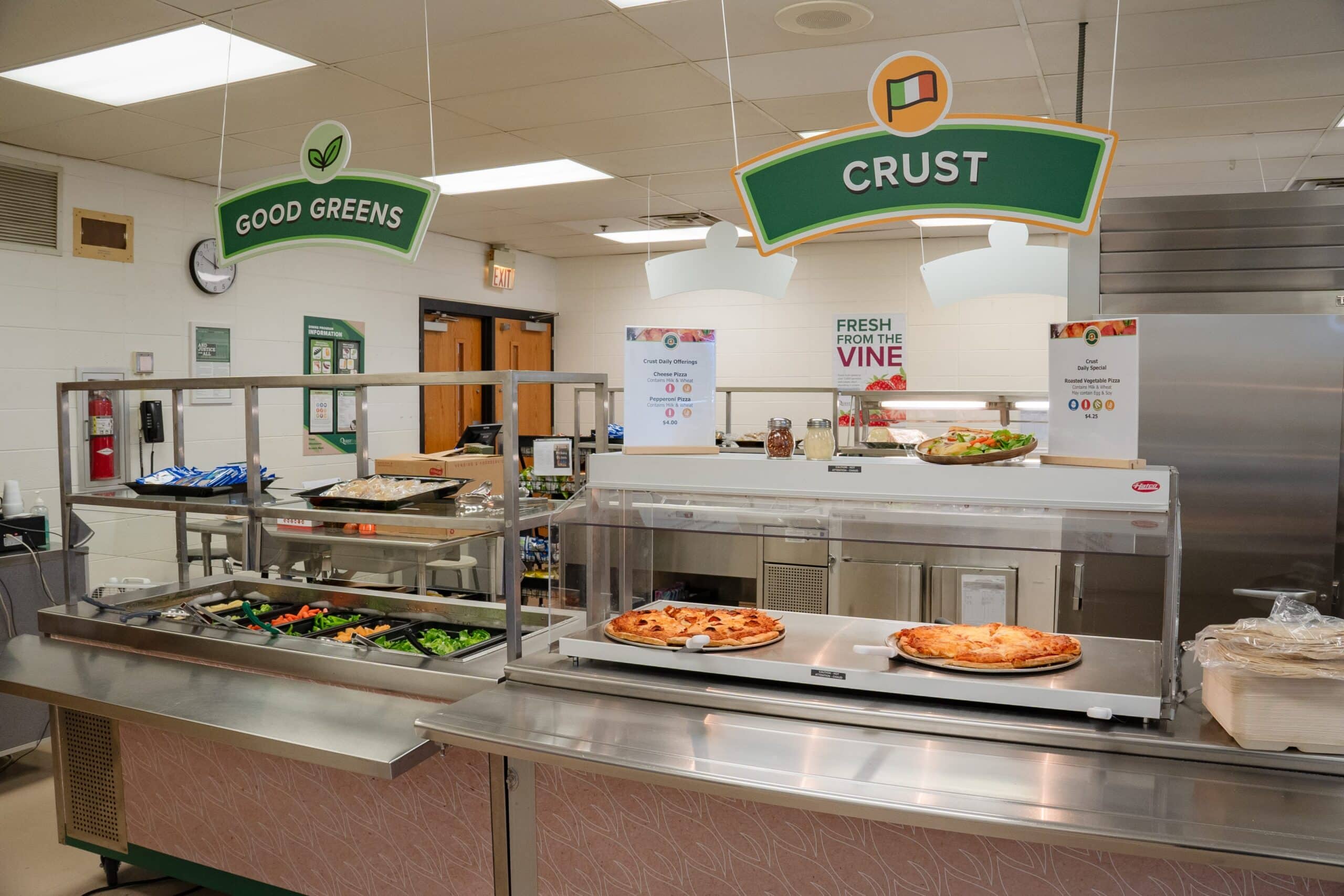 A self serve buffet line with pizza and salad