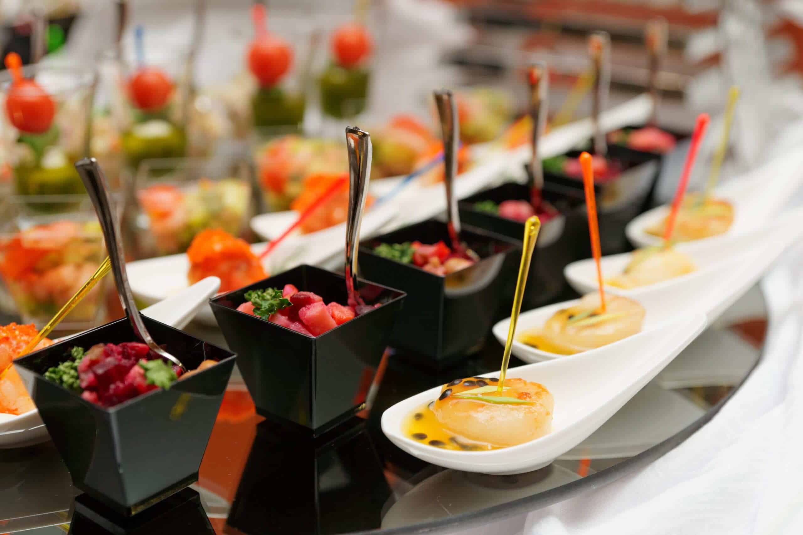 buffet table displaying a variety of dishes, including salads, meats, and desserts, arranged for guests to serve themselves.